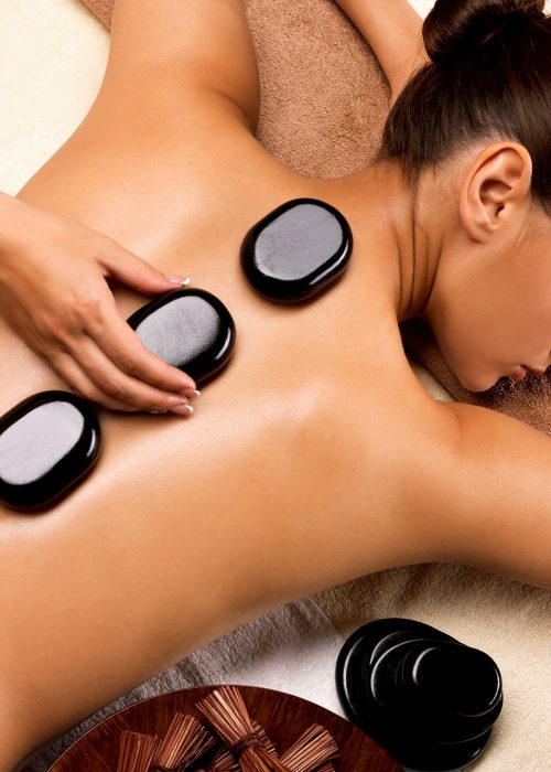 lady laying down getting a hot stone massage